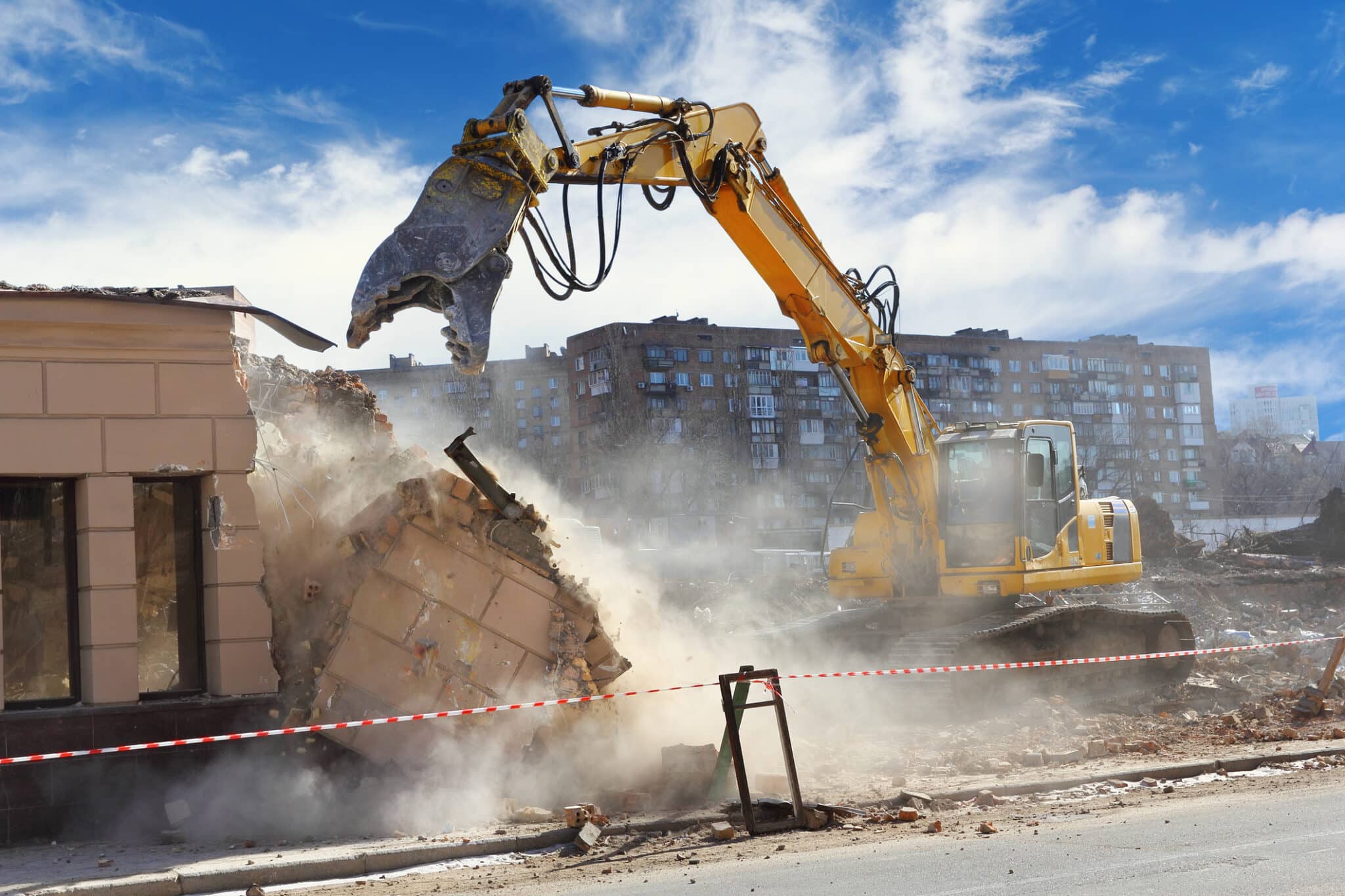 Bulldozer crushing the building at construction site